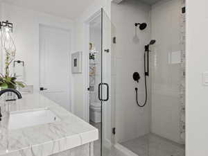 Master Bathroom with vanity, toilet, and walk in shower