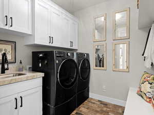 Mudroom/Washroom featuring cabinets, washing machine and dryer, and sink. Directly off garage entrance.