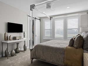 Ensuite Master bedroom with carpet flooring, ceiling fan, and a barn door