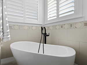 Master Bathroom with stand alone soaking tub, and intricate tile work.