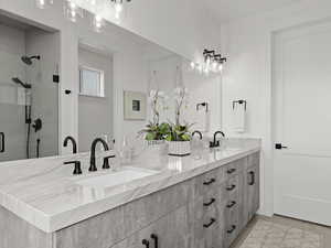 Master Bathroom with heated floors featuring vanity and a shower with shower door