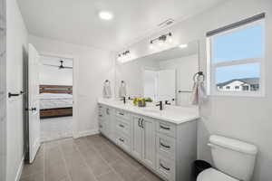 Bathroom with tile patterned floors, vanity, and toilet