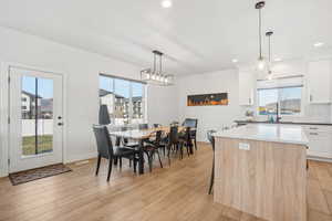 Dining space featuring light hardwood / wood-style flooring and a healthy amount of sunlight