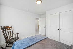 Carpeted bedroom with a closet