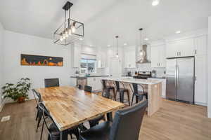 Dining space featuring light hardwood / wood-style floors and sink