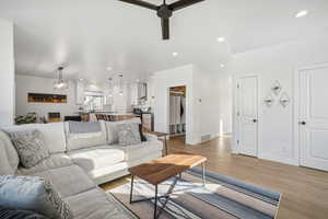 Living room featuring ceiling fan and light hardwood / wood-style floors