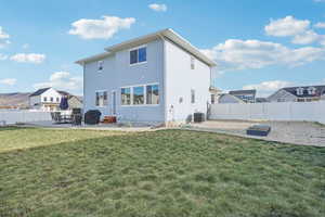 Back of house featuring a yard, a patio, and central AC unit