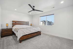 Carpeted bedroom featuring ceiling fan