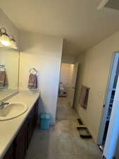 Primary Bathroom with private wash room, large shower, and large sink area with walk-in closet off to the side and entrance from primary bedroom.