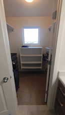 View of walk in closet primary bedroom