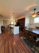 Dining space with a view!! Enjoy with dark hardwood flooring and ceiling fan, sliding glass door out onto a deck with beautiful east facing views!