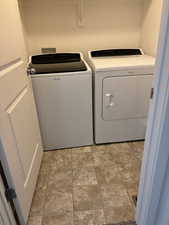Clothes washing area with washer and dryer and shelves