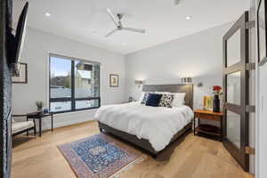 Bedroom with ceiling fan and light wood-type flooring