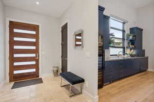 Entrance foyer with sink and light wood-type flooring