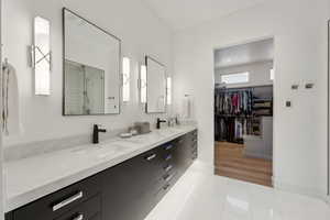 Bathroom with vanity, hardwood / wood-style flooring, and a shower with shower door