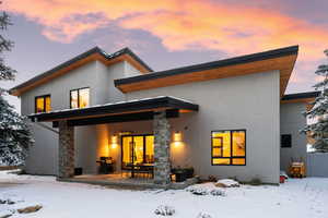 View of snow covered back of property