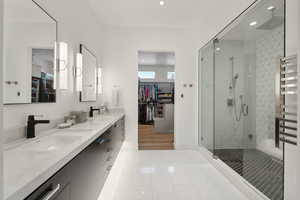 Bathroom with hardwood / wood-style floors, vanity, and a shower with shower door