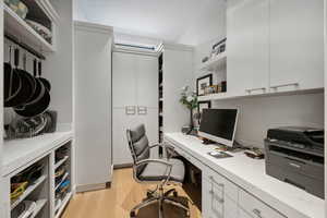 Office with light hardwood / wood-style floors