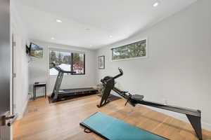 Exercise area with light hardwood / wood-style flooring