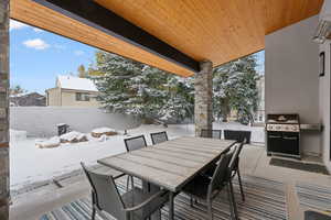 Snow covered patio with area for grilling