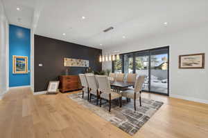 Dining space with light hardwood / wood-style flooring