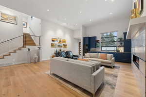 Living room featuring a fireplace, light hardwood / wood-style floors, and sink