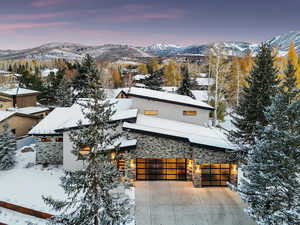 Contemporary home featuring a mountain view and a garage