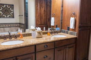 Bathroom featuring vanity and a tub