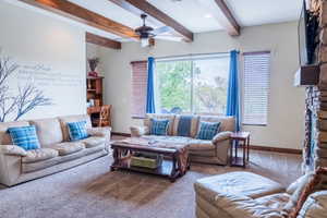 Living room with beam ceiling, ceiling fan, and carpet floors