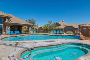 View of pool with a community hot tub and a patio area