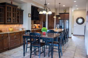 Dining area with sink and a notable chandelier