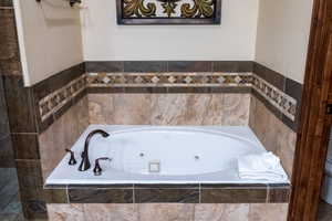 Bathroom with tiled bath and toilet