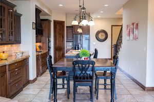 Dining room featuring an inviting chandelier and sink