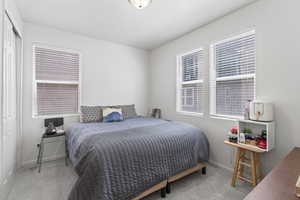 Bedroom with light carpet and a closet