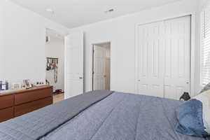 Bedroom with hardwood / wood-style flooring and a closet