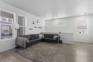 Living room with a textured ceiling and light wood-type flooring