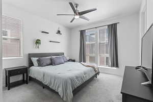 Bedroom featuring ceiling fan and light carpet