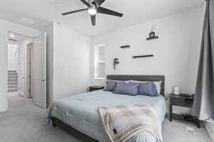 Carpeted bedroom with ceiling fan