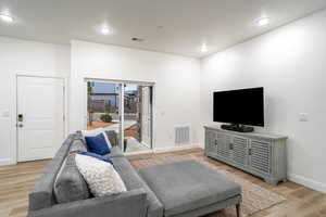 Living room featuring light hardwood / wood-style floors and a textured ceiling