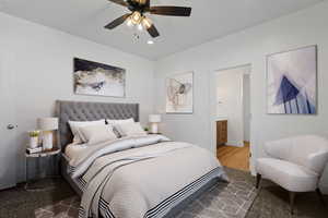 Bedroom with carpet flooring, connected bathroom, and ceiling fan