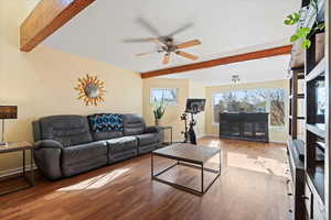 Living room featuring ceiling fan, beamed ceiling, and light wood-type flooring