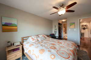 Bedroom with hardwood / wood-style flooring and ceiling fan