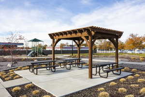 View of community featuring a playground and a pergola