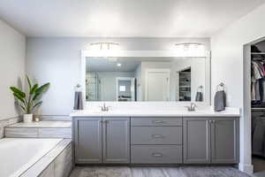 Bathroom featuring a bathing tub and vanity