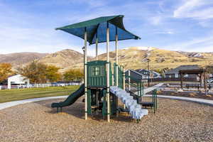 View of play area with a lawn and a mountain view