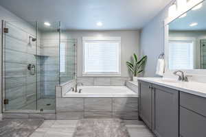 Bathroom with vanity and plus walk in shower