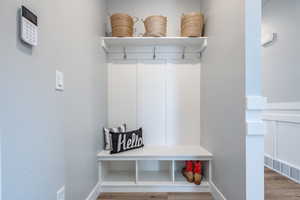 Mudroom with wood-type flooring