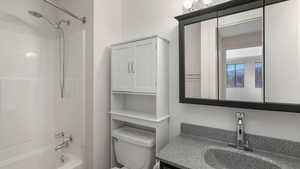 Full bathroom featuring shower / tub combination, vanity, and toilet