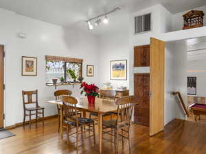 Dining area featuring wood-type flooring, track lighting, and billiards