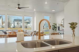 Kitchen featuring a textured ceiling, plenty of natural light, ceiling fan, and sink